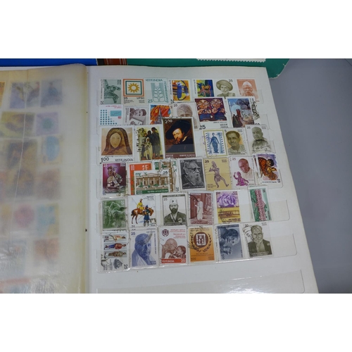 669 - Three stamp albums including Malaysia, India, Guernsey, Isle of Man, etc.