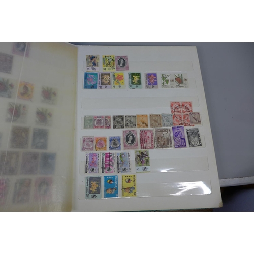 669 - Three stamp albums including Malaysia, India, Guernsey, Isle of Man, etc.