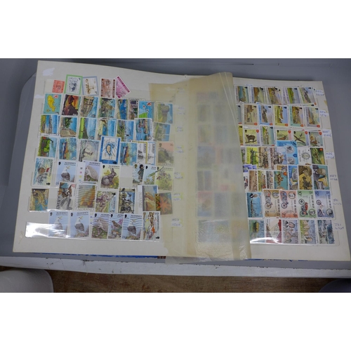 669 - Three stamp albums including Malaysia, India, Guernsey, Isle of Man, etc.