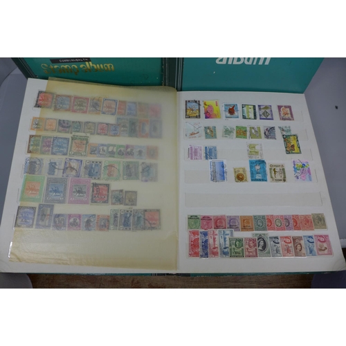 677 - Three stamp albums including Singapore, St. Lucia, Seychelles, British Solomon Islands, Pakistan, Rh... 