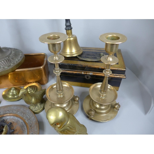 731 - A collection of brass including candlesticks, ornaments, a bell, a copper dish, a door knocker and a... 