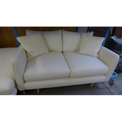 1457 - A white/cream textured weave upholstered four seater, two seater sofa and a footstool