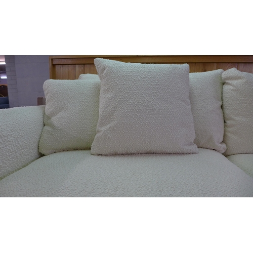 1457 - A white/cream textured weave upholstered four seater, two seater sofa and a footstool