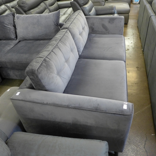 1463 - A grey velvet three seater sofa on dark legs