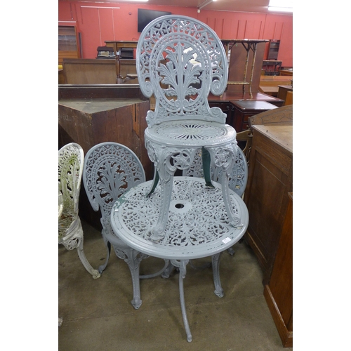 250 - A painted cast aluminium garden table and three chairs