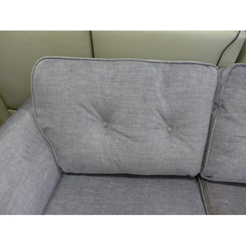 1353 - A grey velvet button back two seater sofa *This lot is subject to VAT