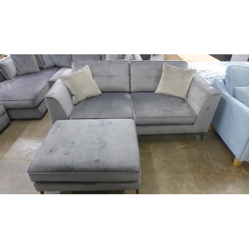 1355 - A grey velvet three seater sofa and footstool