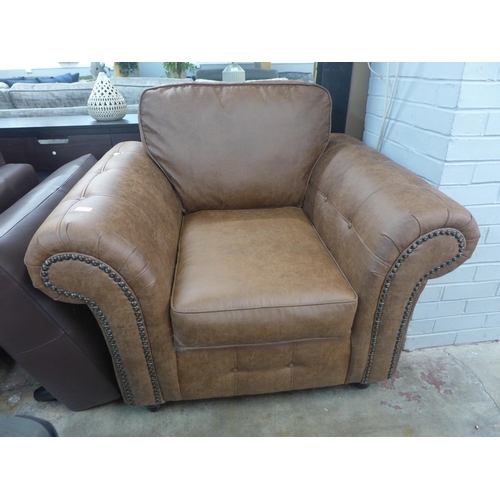1360 - A brown upholstered armchair