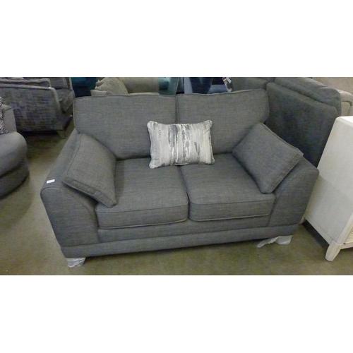 1381 - A charcoal upholstered two seater sofa