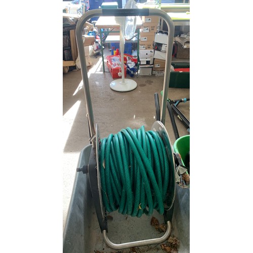 2260 - Metal wheelbarrow with hose on reel