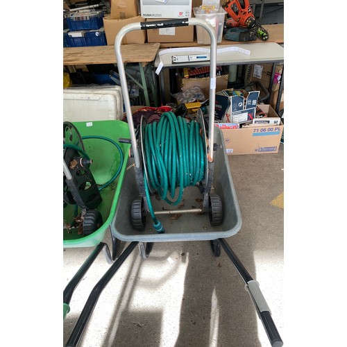 2260 - Metal wheelbarrow with hose on reel