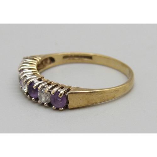 1003 - A 9ct gold, amethyst and cubic zirconia seven stone ring, 1.6g, M