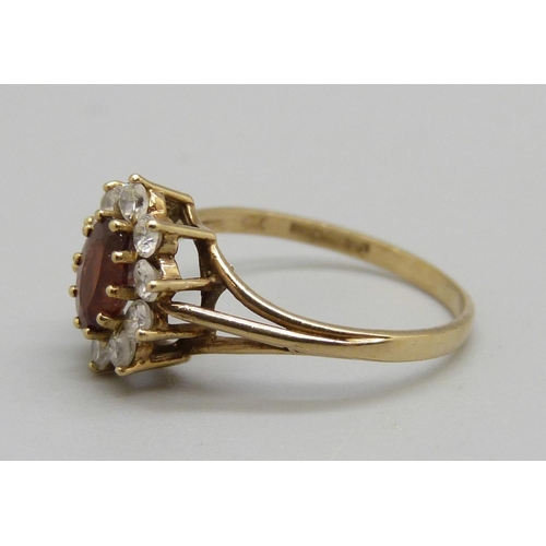 1010 - A 9ct gold, garnet and cubic zirconia cluster ring, 1.7g, M