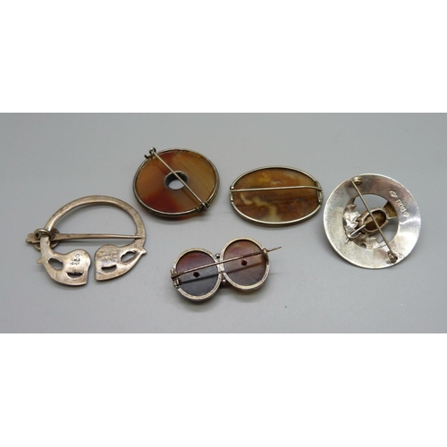 1044 - A hallmarked Scottish silver thistle brooch, a silver Iona kilt pin and three agate set brooches