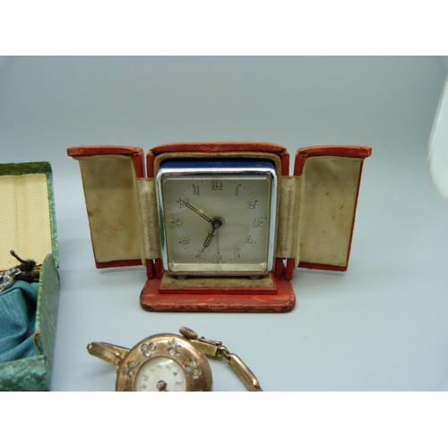 1090 - A cased travel alarm clock, a silver fob watch and two lady's cocktail wristwatches