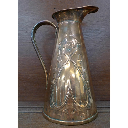 610 - An Art Nouveau copper pitcher, 29cm