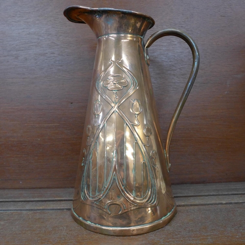 610 - An Art Nouveau copper pitcher, 29cm