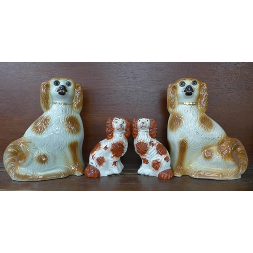 612 - Two pairs of Staffordshire spaniels, one of smaller pair cracked