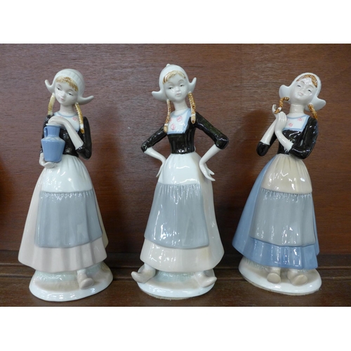 615 - Three figures of Dutch girls in traditional dress, 26cm