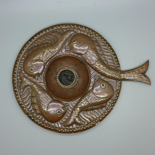 625 - An Arts and Crafts copper candle holder with large fish handle in the manner of John Pearson (no ide... 