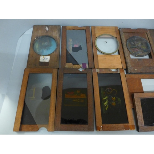 633 - A collection of wooden framed magic lantern slip slides, some incomplete