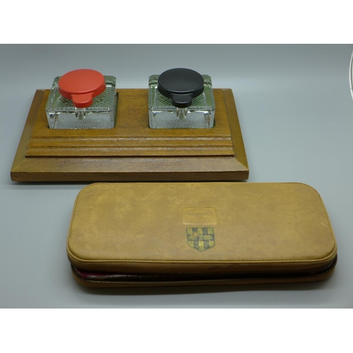 648 - A wooden ink stand with twin glass inkwells and a geometry set