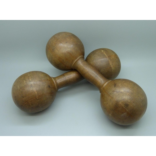655 - A pair of antique wooden dumbbells, circa 1900/1910, stamped Gamages of Holborn, 24cm, 851g (30oz) c... 