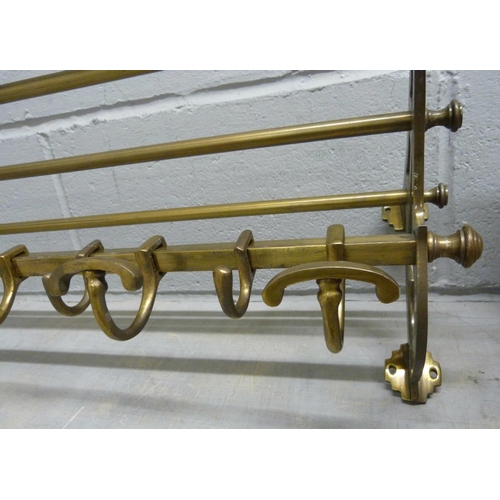680 - An antique brass railway carriage luggage rack, length 91cm with decorative brackets