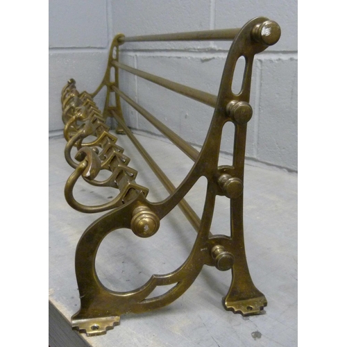 680 - An antique brass railway carriage luggage rack, length 91cm with decorative brackets