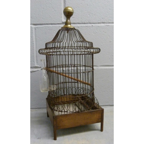 690 - A French wire work bird cage with original glass bottle, circa 1850-1880, 53cm tall, damage to lower... 