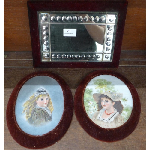 691 - Two Victorian portraits of young girls, both oils on opaque glass and a wall mirror with velvet bord... 