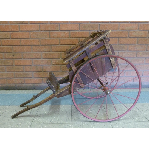 700 - An estate-built late 19th Century dog cart with simple inlay, safety chain and red painted wheels, f... 