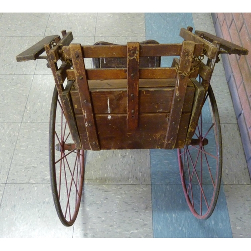 700 - An estate-built late 19th Century dog cart with simple inlay, safety chain and red painted wheels, f... 