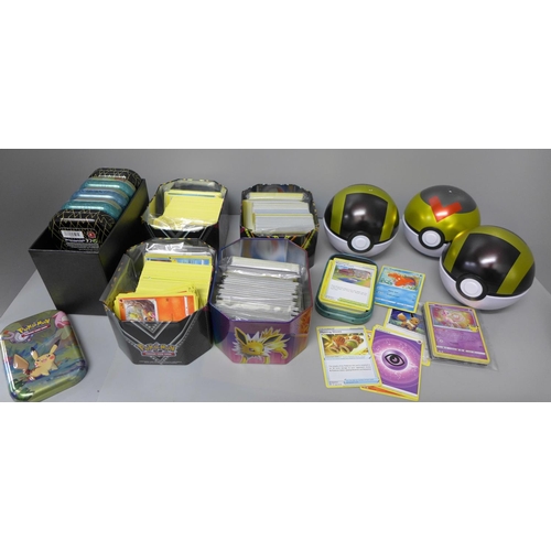 711 - Four tins each with 250 Pokemon cards, six smaller tins each with sixty Pokemon cards and three Poke... 