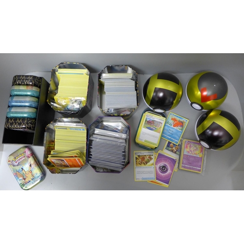 711 - Four tins each with 250 Pokemon cards, six smaller tins each with sixty Pokemon cards and three Poke... 