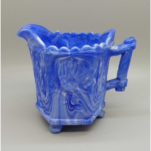 735 - A late 19th Century slag glass jug, possibly Sowerby or Davidsons, the blue marbled glass on raised ... 