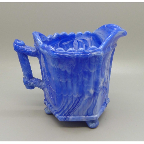 735 - A late 19th Century slag glass jug, possibly Sowerby or Davidsons, the blue marbled glass on raised ... 