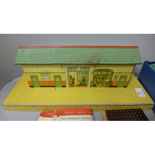 750 - A Hornby tin-plate station and a box of Bayko