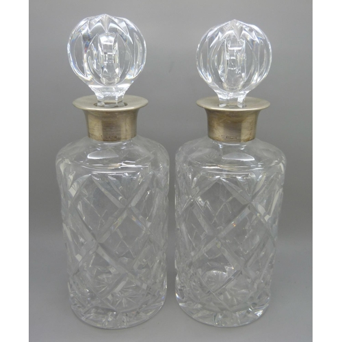 820 - A pair of silver mounted crystal glass decanters