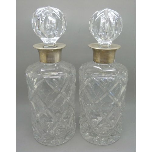 820 - A pair of silver mounted crystal glass decanters