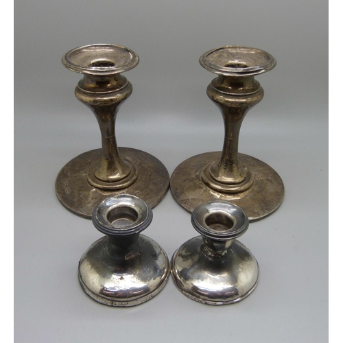 825 - Two pairs of silver candlesticks, a/f