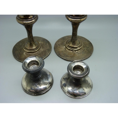 825 - Two pairs of silver candlesticks, a/f