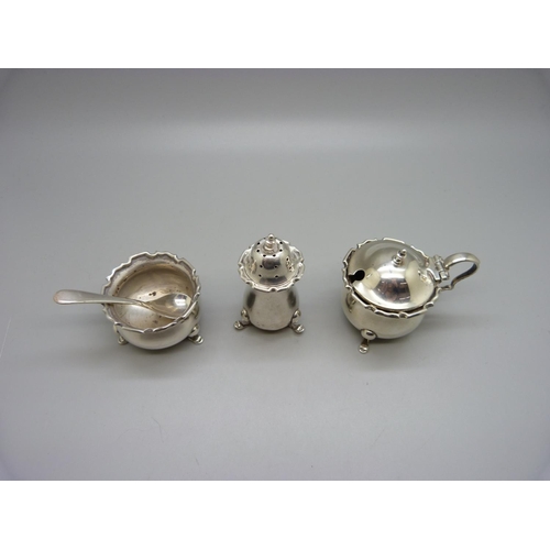 856 - A three piece silver cruet set, Birmingham 1926, and a silver salt spoon, 105g