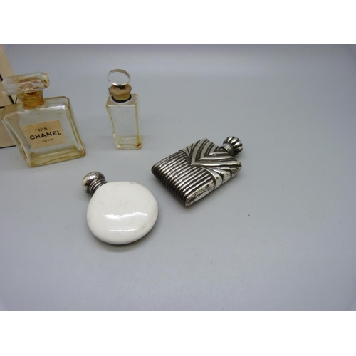 857 - A silver topped crested scent flask, Birmingham 1909, a Chanel No.5 perfume bottle and two others