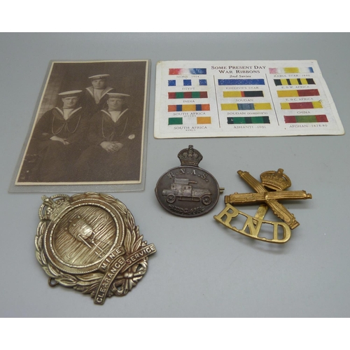 891 - Three British military badges and two postcards, (Mine badge a/f)