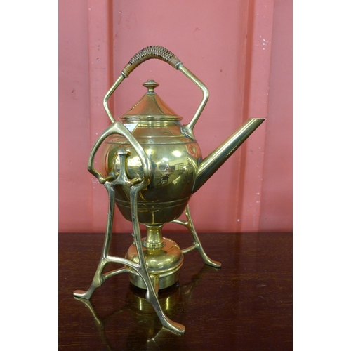 10 - An Arts and Crafts brass spirit kettle on stand