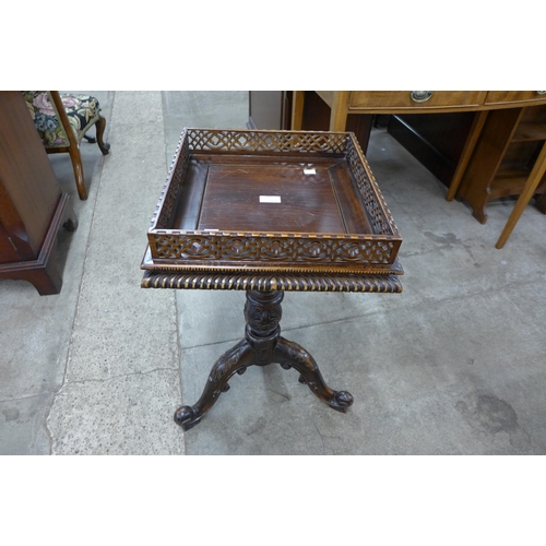 106 - A Chippendale style carved mahogany urn stand