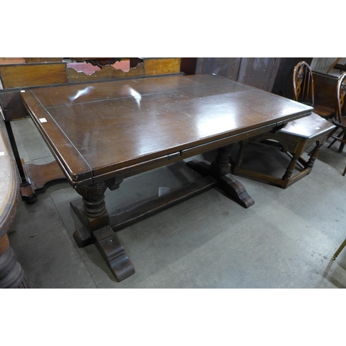 134 - A 17th Century style carved oak extending refectory table