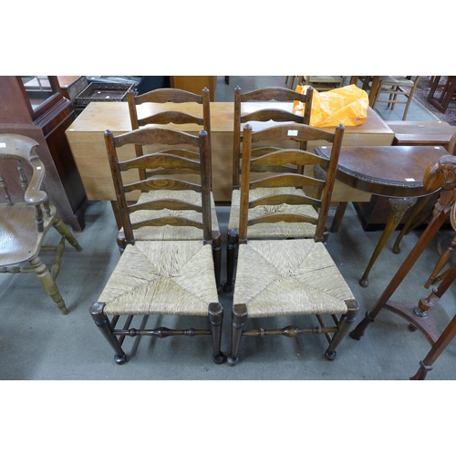 147 - A set of four oak and rush seated ladderback chairs