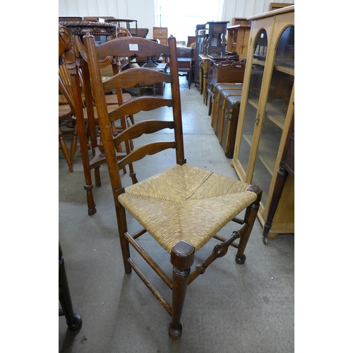 147 - A set of four oak and rush seated ladderback chairs